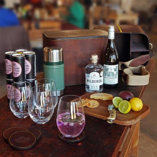 field bar, leather, wine, gin, leather coasters, cutting board, crackers, tonic, cheese, lemons