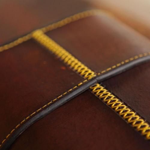 yellow stitching, leather carrier, leather, wine carrier