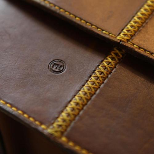 leather product, yellow stitching, initials, field bar